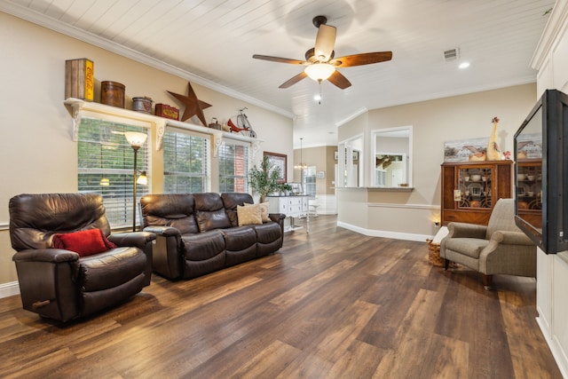 living room with ornamental molding, dark wood-type flooring, and ceiling fan with notable chandelier