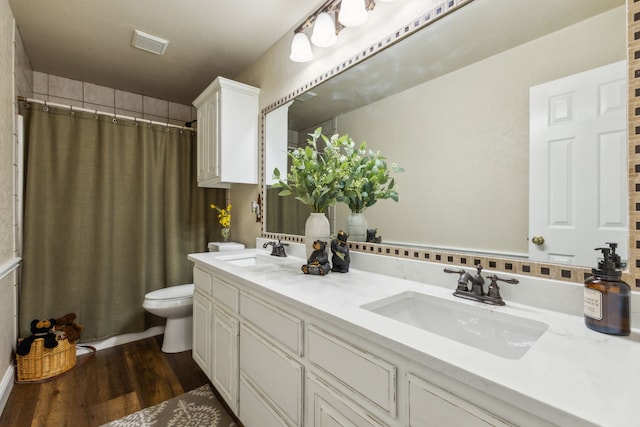 bathroom with vanity, toilet, a shower with shower curtain, and wood-type flooring