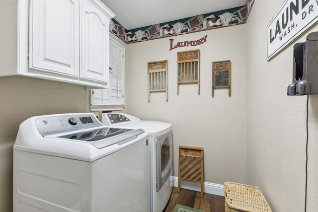 washroom with dark hardwood / wood-style flooring, washer and clothes dryer, and cabinets