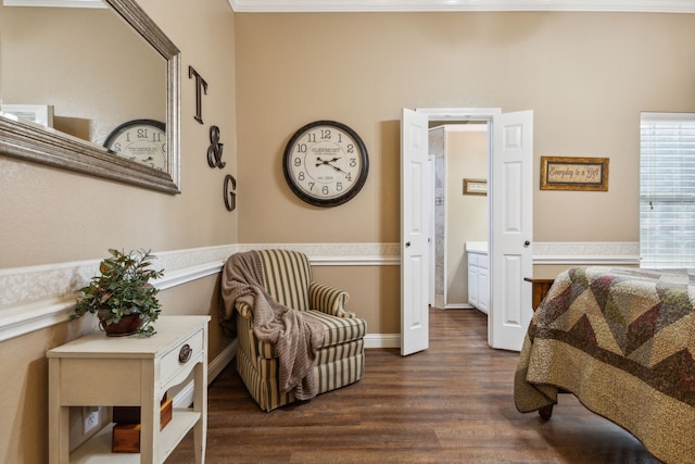 sitting room with ornamental molding and dark hardwood / wood-style flooring