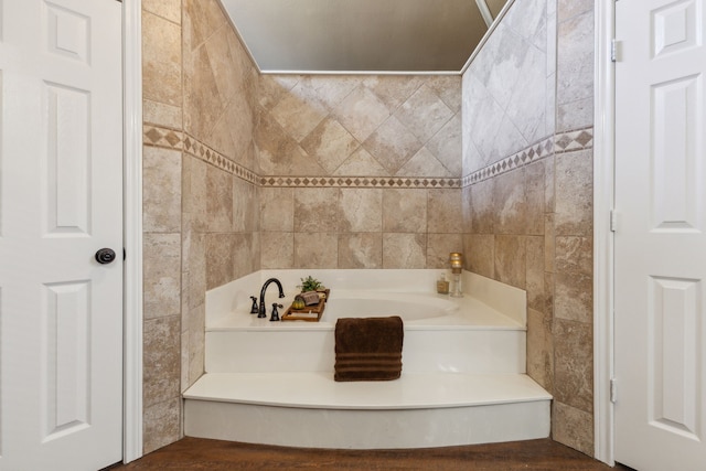 bathroom featuring a bathing tub and tile walls