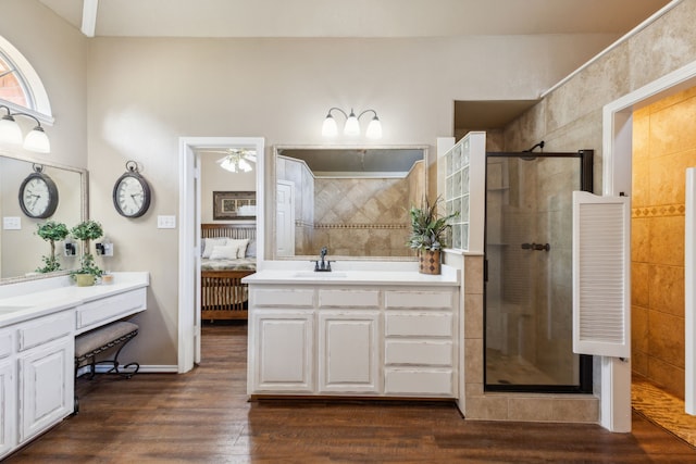 bathroom featuring hardwood / wood-style flooring, vanity, and an enclosed shower