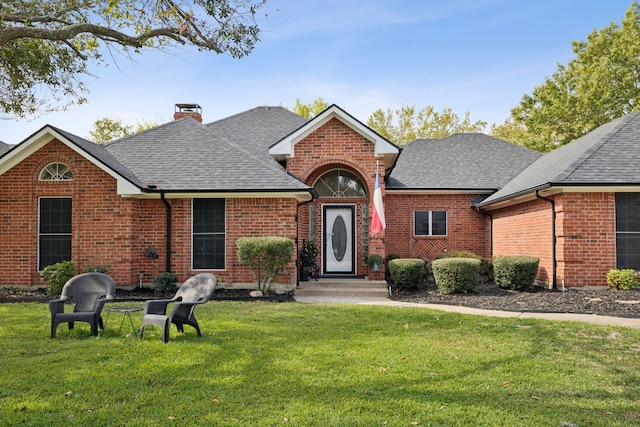308 N Elm, Quinlan, TX 75474 - single story home featuring brick siding, a front lawn, roof with shingles, and a chimney