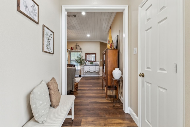 hallway with crown molding and dark hardwood / wood-style floors