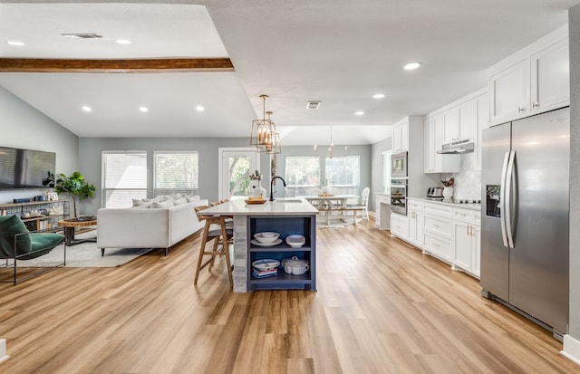 kitchen featuring an island with sink, hanging light fixtures, white cabinetry, stainless steel appliances, and light hardwood / wood-style flooring