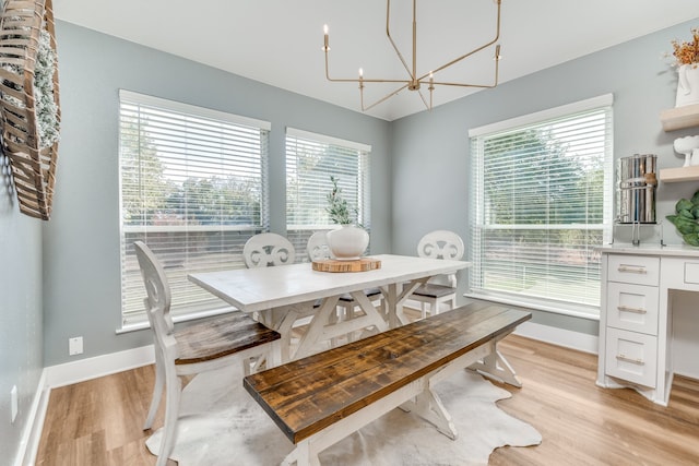 dining area with an inviting chandelier, light hardwood / wood-style floors, and a healthy amount of sunlight