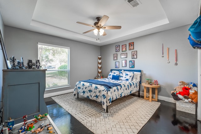 bedroom featuring a raised ceiling and ceiling fan