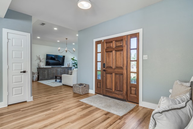 foyer featuring a notable chandelier and light wood-type flooring