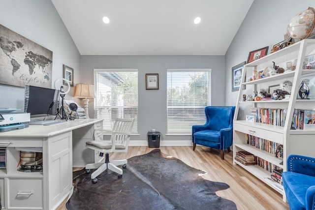 home office featuring light hardwood / wood-style floors and vaulted ceiling