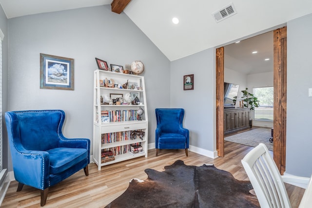 sitting room with hardwood / wood-style floors and lofted ceiling with beams