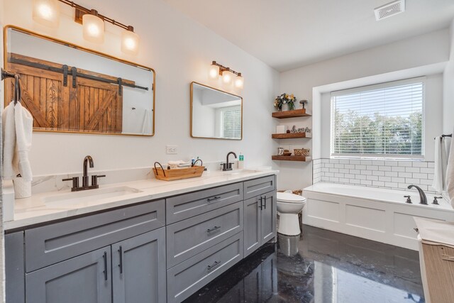 bathroom featuring vanity, toilet, and a washtub