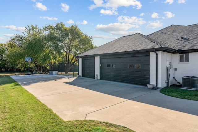 garage featuring central AC and a lawn