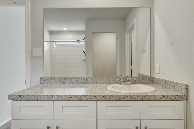 bathroom featuring vanity and a shower