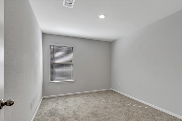 empty room featuring light carpet