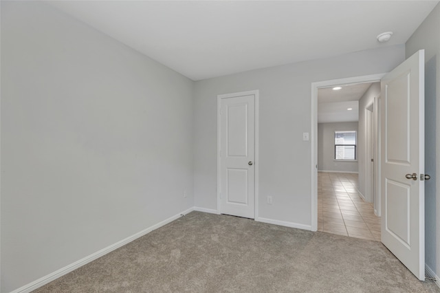 unfurnished room with light colored carpet