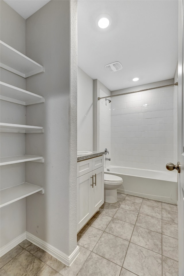 full bathroom featuring vanity, toilet, tile patterned floors, and tiled shower / bath