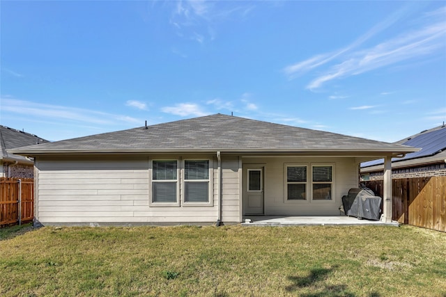 rear view of property with a patio area and a lawn