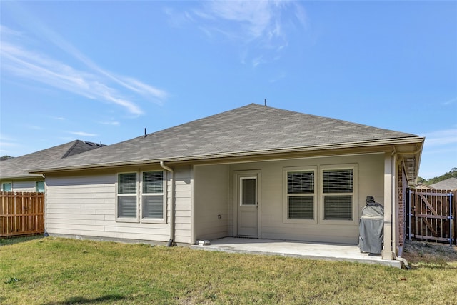 back of house featuring a patio area and a yard