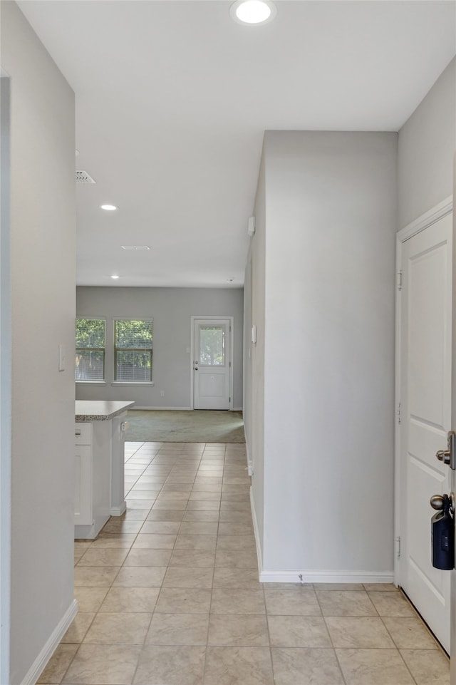 corridor with light tile patterned floors