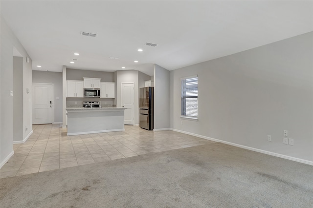 unfurnished living room with light carpet