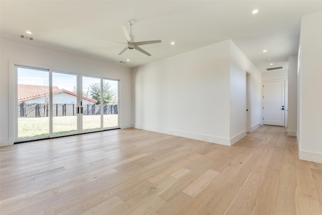 unfurnished room with ceiling fan and light wood-type flooring