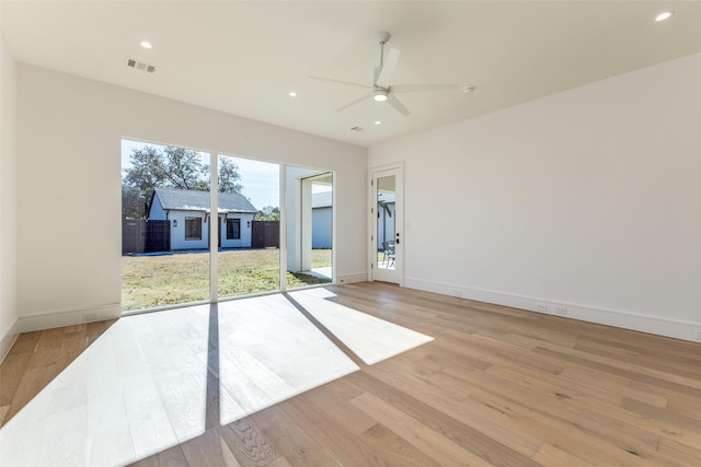 empty room featuring ceiling fan and light hardwood / wood-style flooring