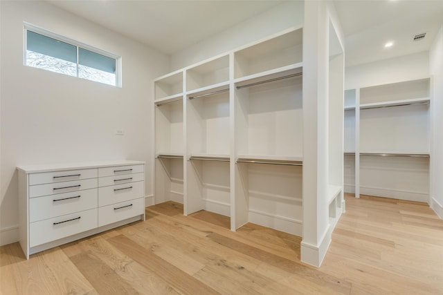 spacious closet with light hardwood / wood-style floors