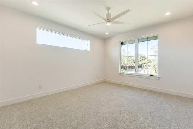 unfurnished room with carpet flooring and ceiling fan