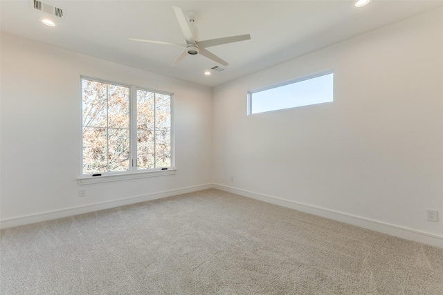 carpeted empty room featuring ceiling fan