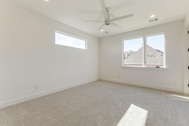 empty room featuring light colored carpet and ceiling fan