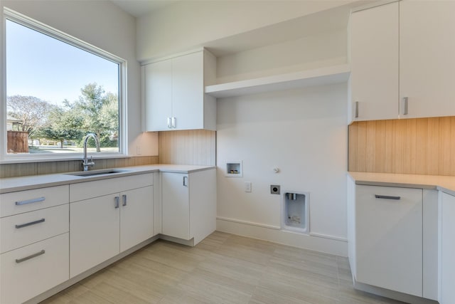 kitchen with white cabinetry and sink