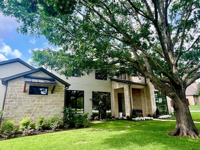 7302 Currin Dr, Dallas, TX 75230 - view of front of home with stone siding and a front lawn