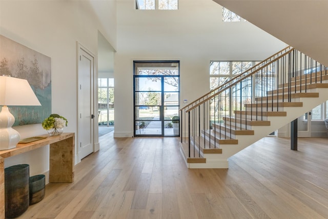 entryway featuring light hardwood / wood-style floors and a high ceiling