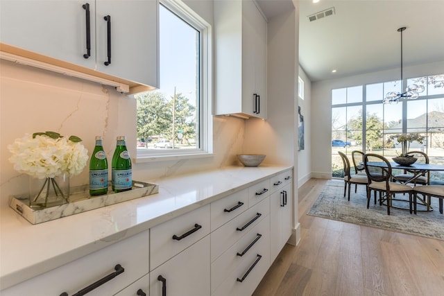 kitchen featuring white cabinets and decorative backsplash