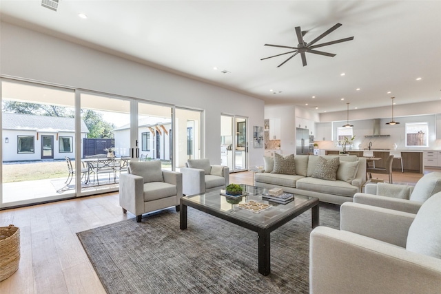 living room featuring ceiling fan and hardwood / wood-style flooring