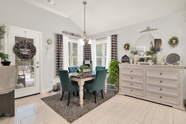 dining room featuring lofted ceiling, ornamental molding, an inviting chandelier, and plenty of natural light