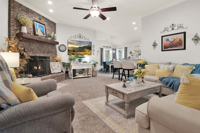 living room with crown molding, ceiling fan, a fireplace, and light colored carpet