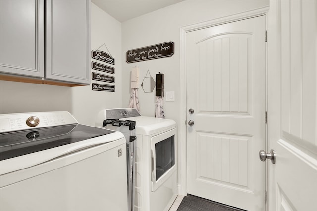 clothes washing area with independent washer and dryer and cabinets