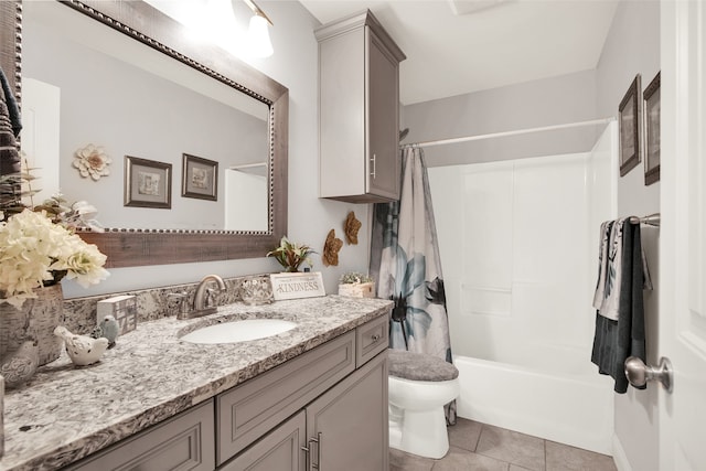 full bathroom featuring toilet, vanity, tile patterned floors, and shower / tub combo