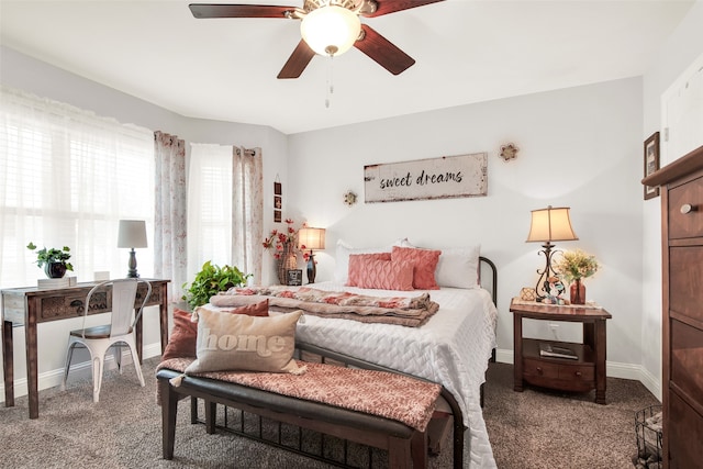 carpeted bedroom featuring multiple windows and ceiling fan