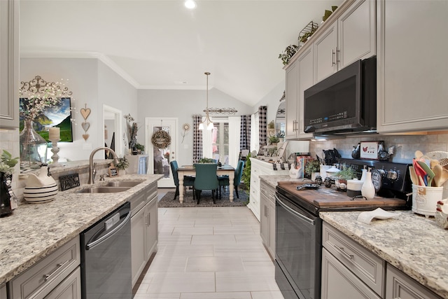 kitchen featuring sink, backsplash, stainless steel appliances, lofted ceiling, and gray cabinets