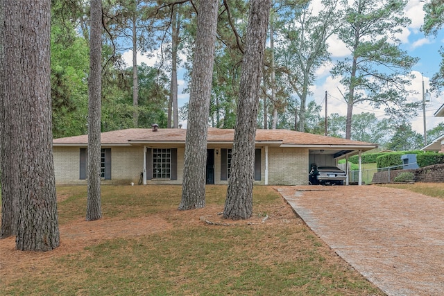 ranch-style home featuring a carport and a front yard