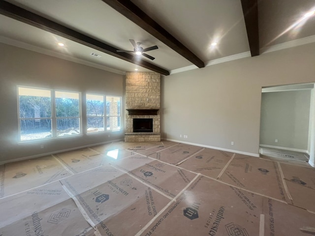 unfurnished living room featuring ceiling fan, a fireplace, and beam ceiling