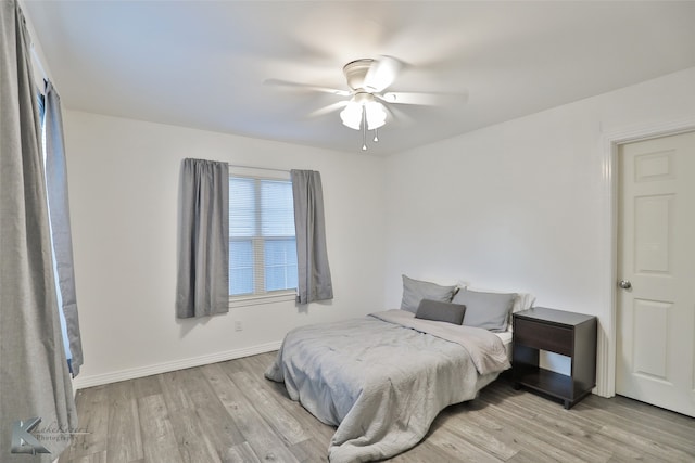 bedroom with light hardwood / wood-style flooring and ceiling fan