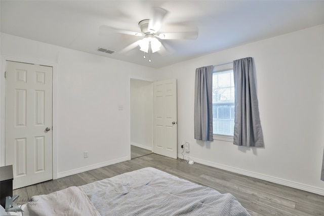 bedroom with hardwood / wood-style flooring and ceiling fan