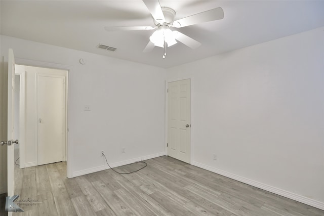 spare room featuring light wood-type flooring and ceiling fan