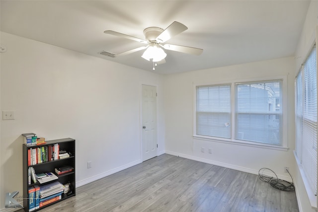 spare room with light hardwood / wood-style floors and ceiling fan