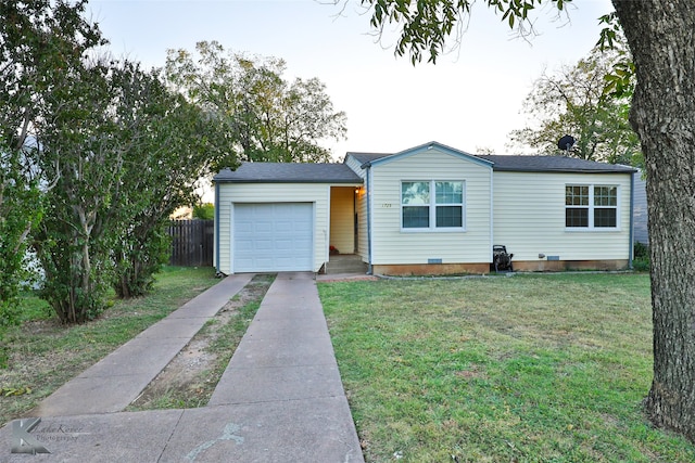 single story home featuring a front lawn and a garage