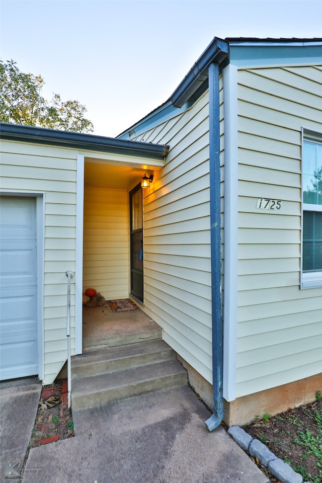 doorway to property with a garage