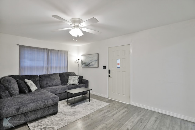 living room with light hardwood / wood-style floors and ceiling fan